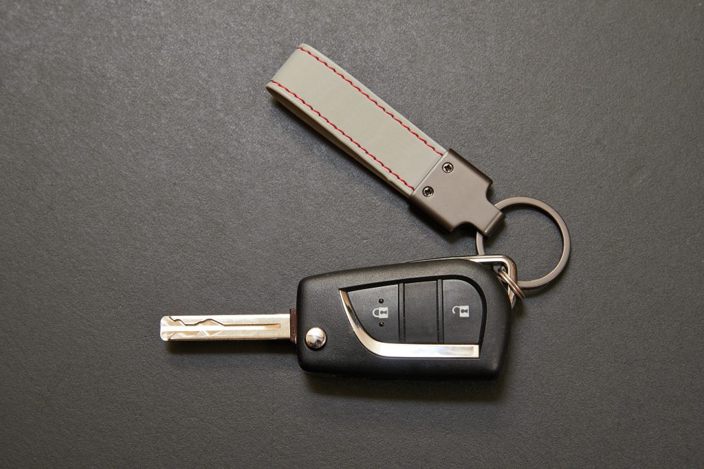 Hybrid key car with blank label on black wooden table